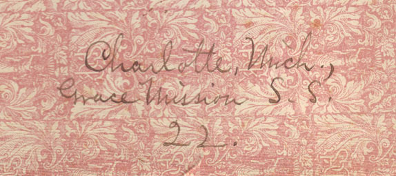  A portion of the other of the two front rose colored floral end-papers with the address; ‘Michigan, Grace Mission S. S.’