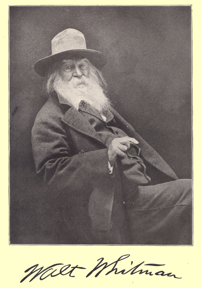 A black and white photograph of Walt Whitman.  He is seated, with a long white beard, suit and hat.  An autograph,  his signature, in his own writing, is below the portrait.