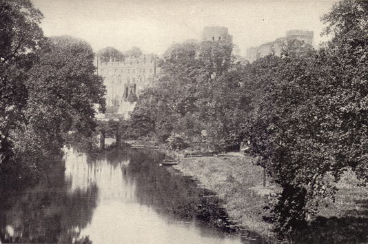 Black and white photograph of Warwick Castle, England, seen in the distance, with trees and a river in the foreground, taken in the late 19th century